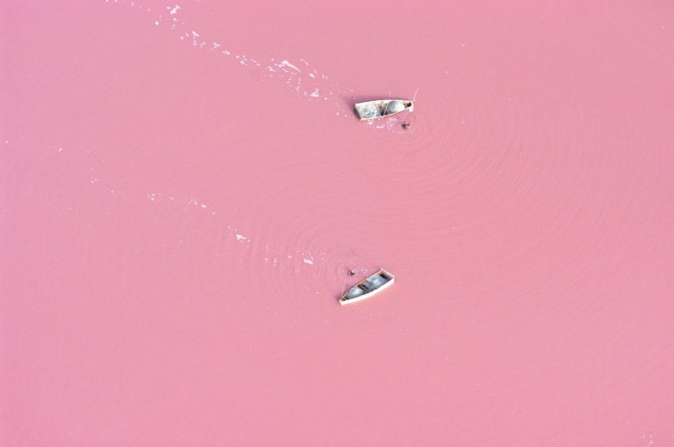 小船航行在玫瑰粉色的湖水，美麗的像是夢一般的場景。(圖片來源／reversehomesickness）