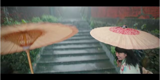 劇中嚴澤坤、志村雅子於黃金博物館旁石階嬉戲雨中。(圖片來源／youtube）