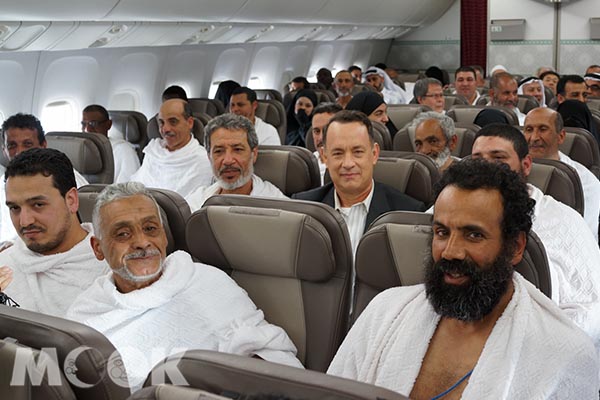 《梭哈人生》搭飛機劇照，與阿拉伯人齊坐畫面逗趣。(圖片提供／采昌國際)