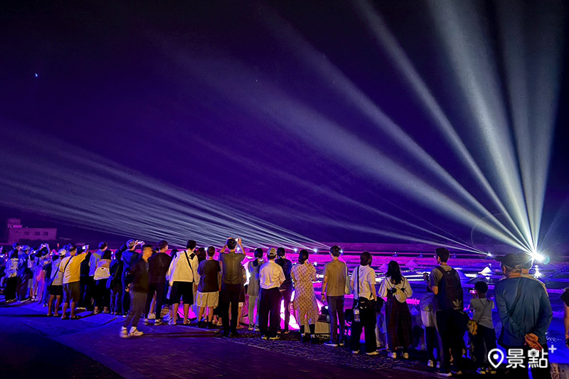 遊客在北門井仔腳鹽田欣賞燈光秀。